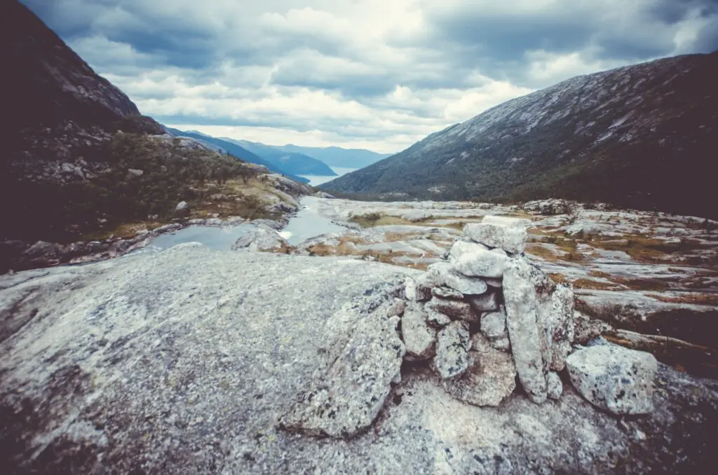 rock cairn overlooking a Norwegian fjord landscape