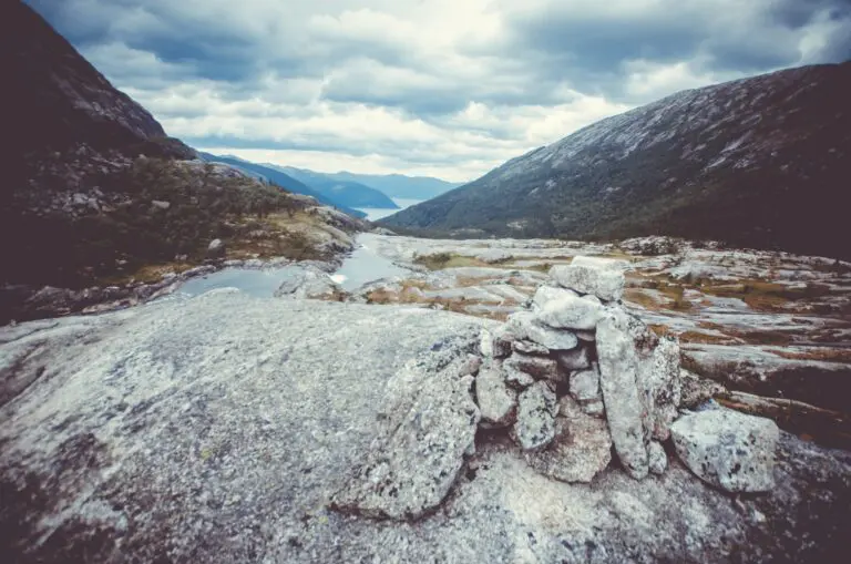 rock cairn overlooking a Norwegian fjord landscape