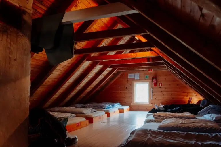 wooden attic dormitory with beds and a window in Norway