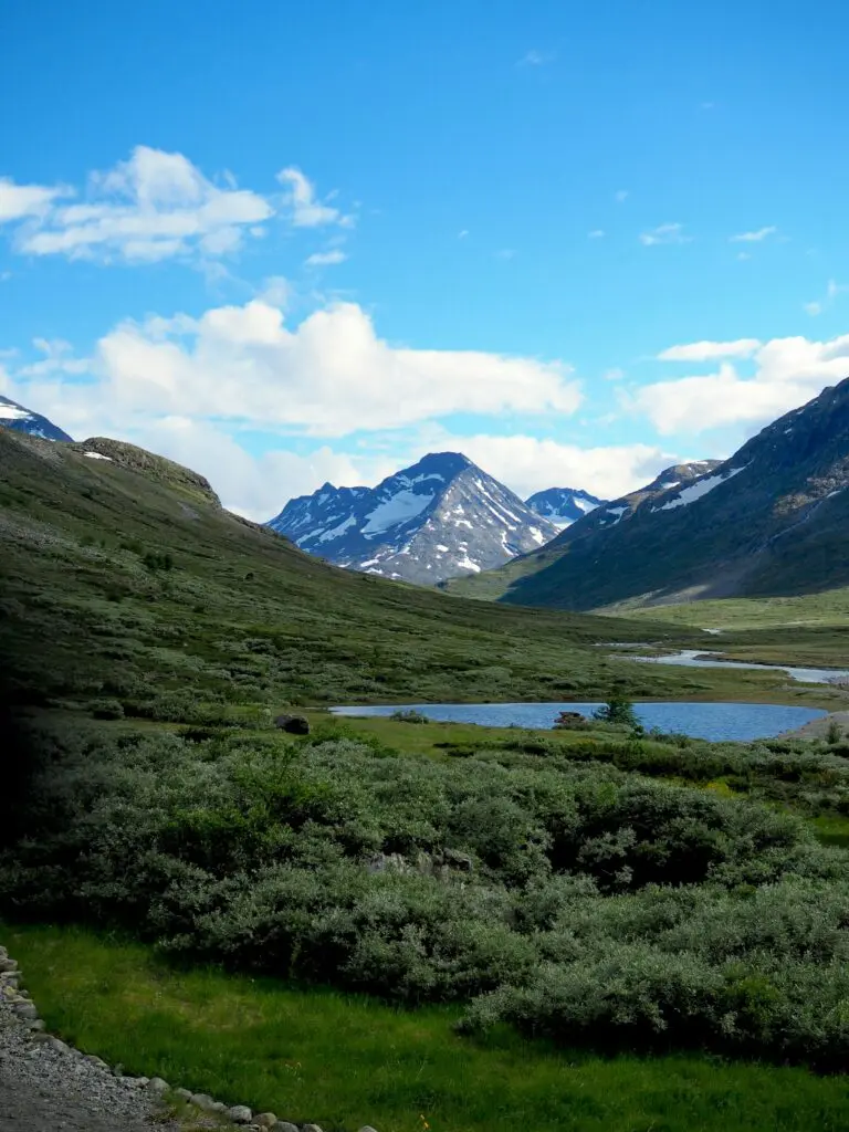a mountain range with a lake in the foreground